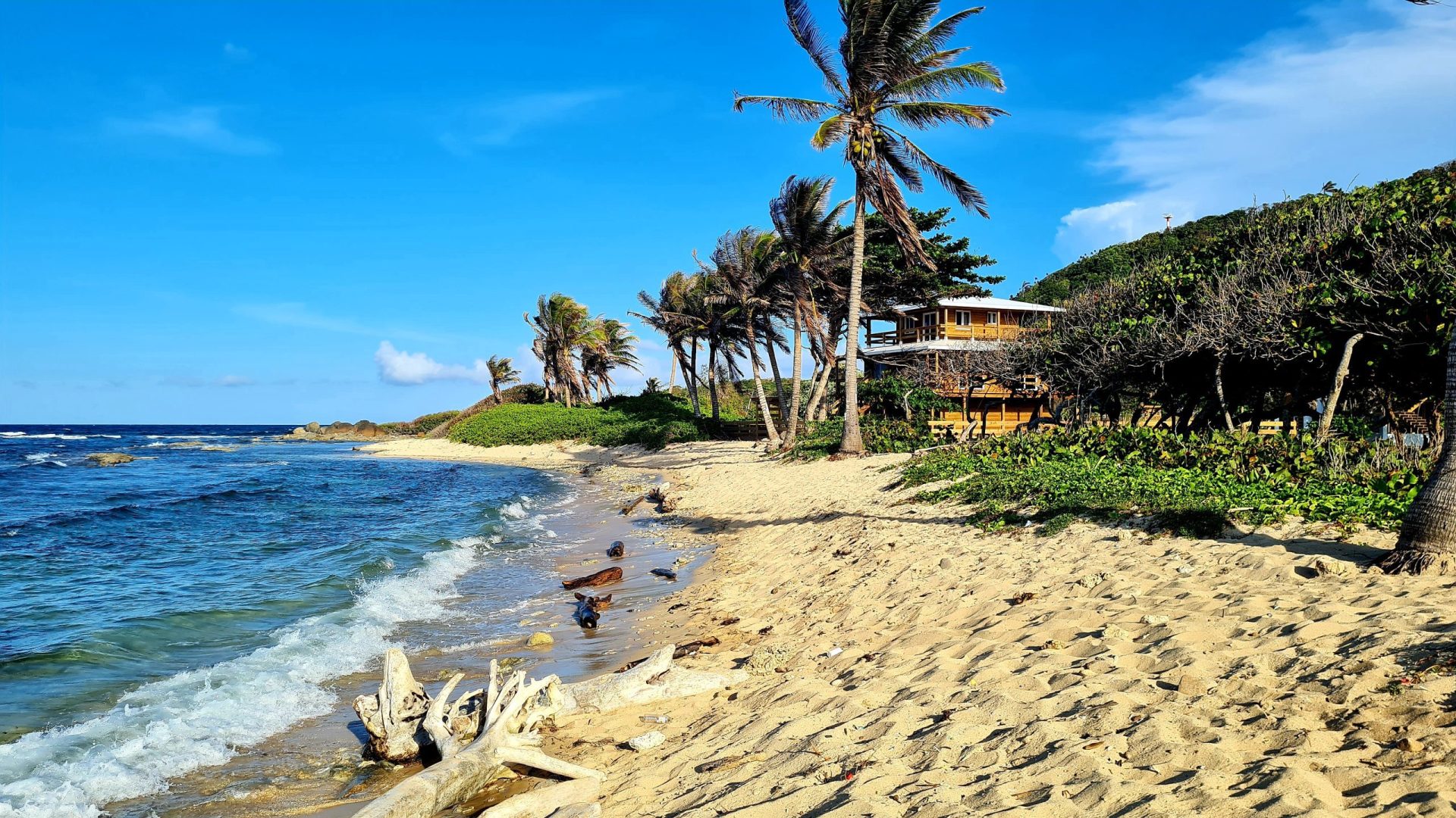 Secluded beach in Utila, Honduras with a remote villa
