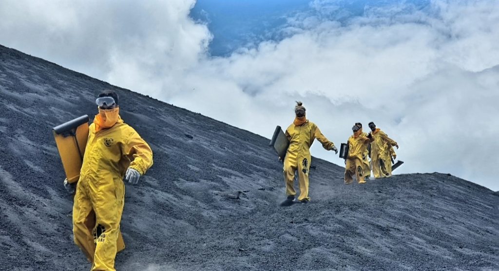 A group of people volcano boarding in Nicaragua
