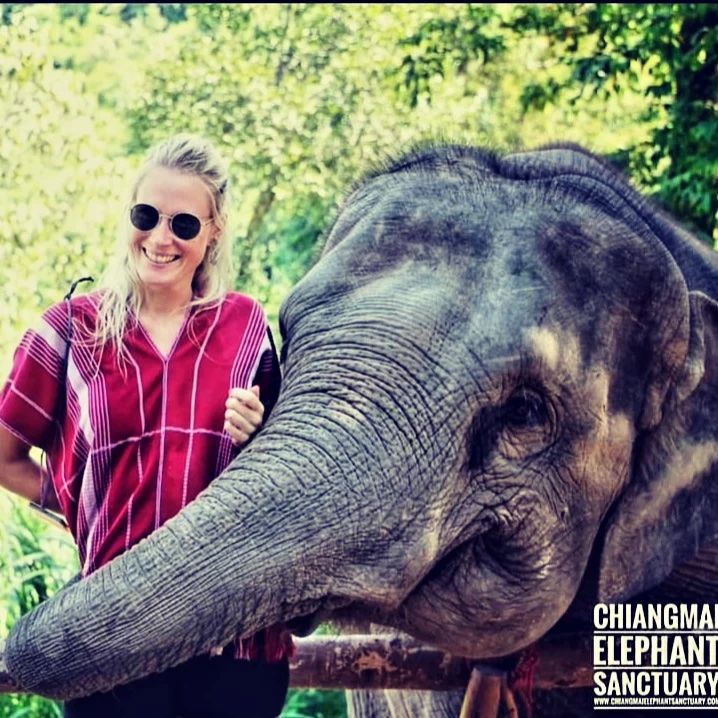 Girl on a long term travel trip, spending the day in an elephant sanctuary