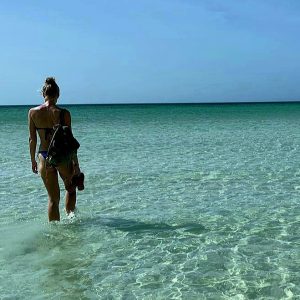 Living the nomadic lifestyle: a girl walking in the sea