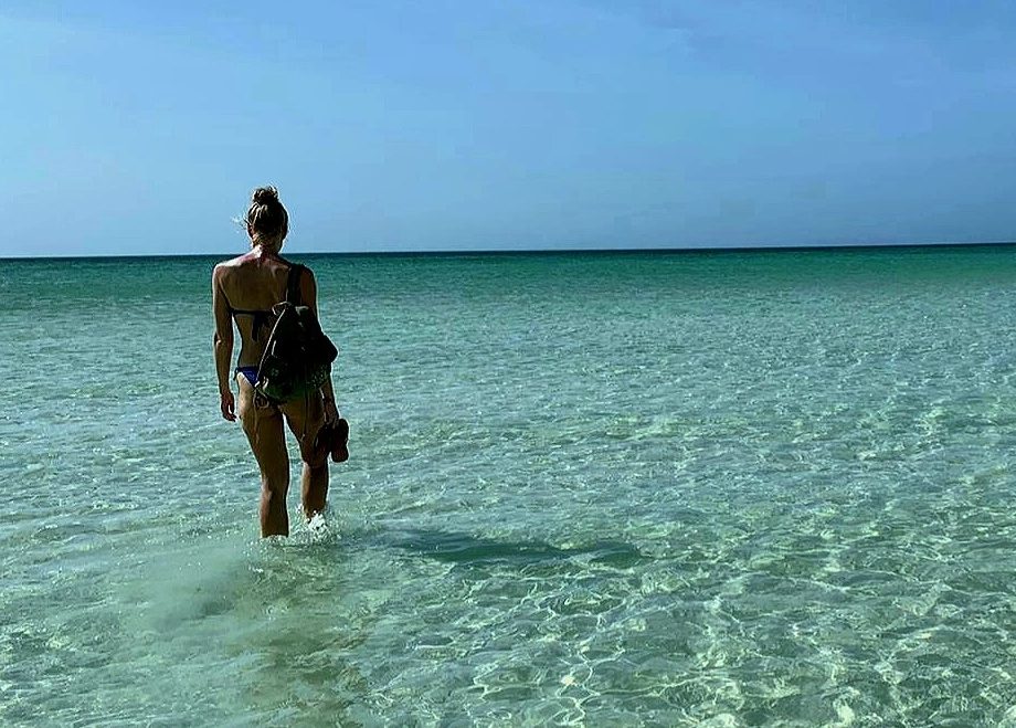 Living the nomadic lifestyle: a girl walking in the sea