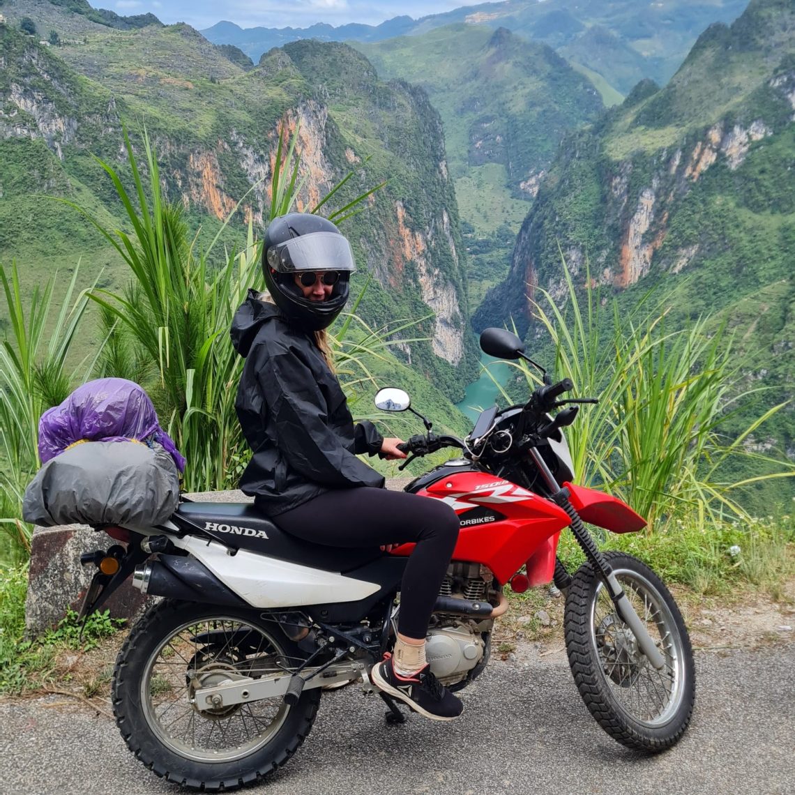 Motorbiking in Vietnam - A girl on a motorbike in front of a stunning landscape in the north