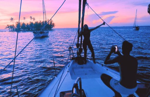 Social media and travel trends: a man taking a picture of a girl on a boat