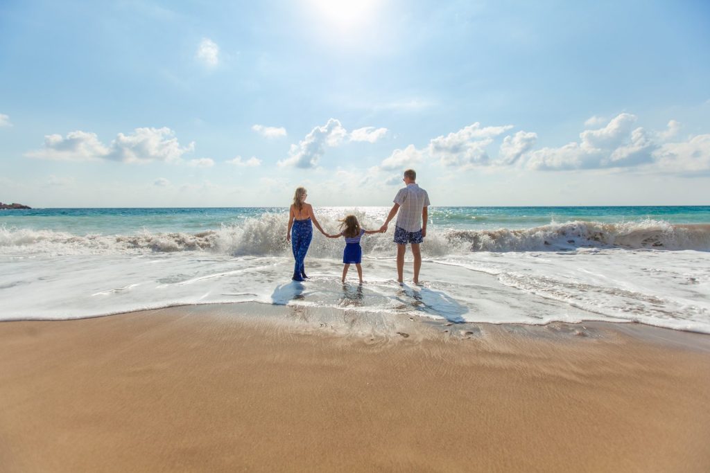 Parents with kids, feet in the water and living the nomadic lifestyle
